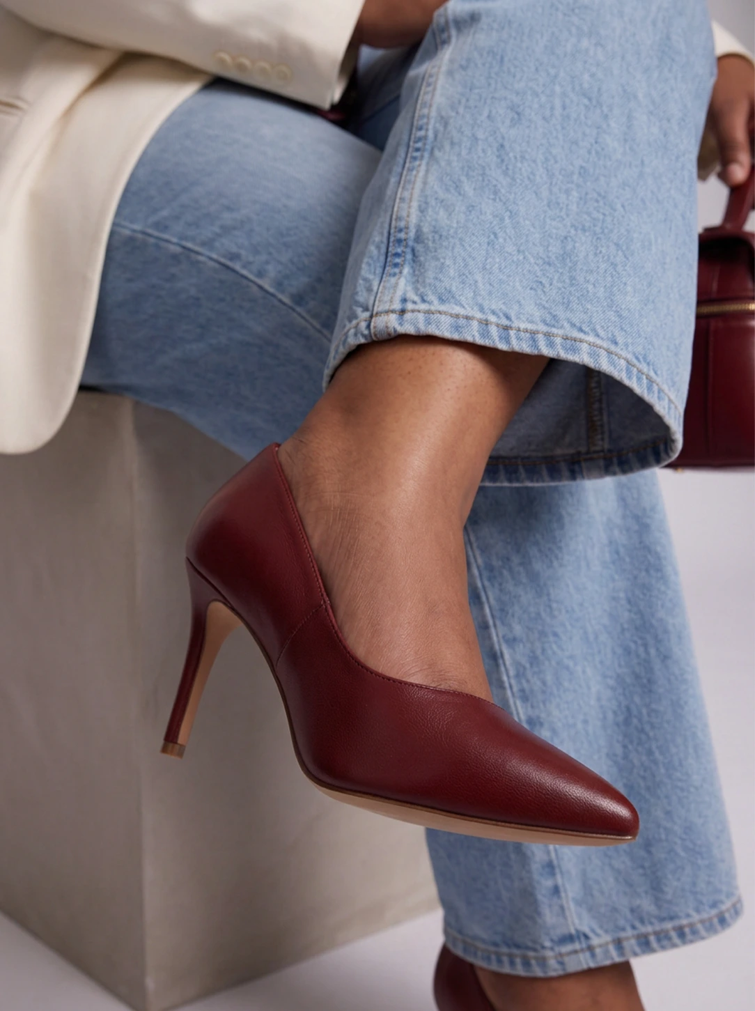 Burgundy pointed-toe pumps with slim heels
